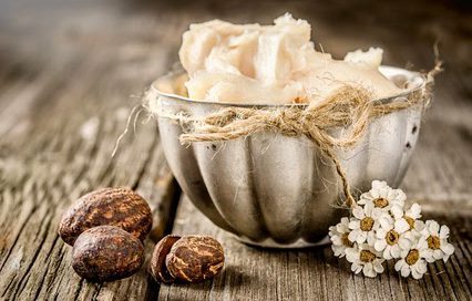 Shea butter and nuts on a wood
